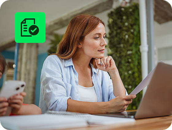 user reviewing itemized deductions with H&R Block Deluxe Online Tax Filing on a laptop