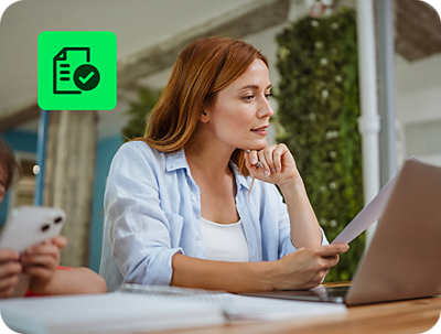 user reviewing itemized deductions with H&R Block Deluxe Online Tax Filing on a laptop