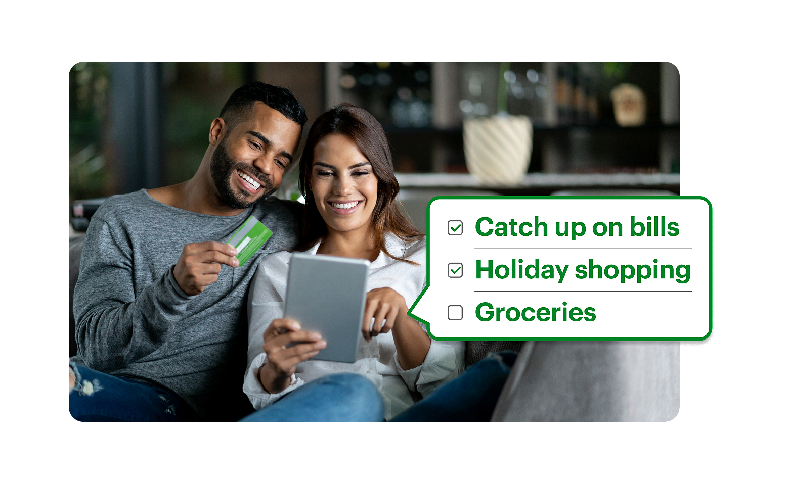 Couple on the couch buying presents with their Emerald Advance Loan