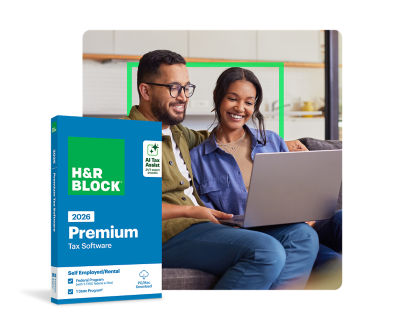 Couple reviewing tax documents and using H&R Block Premium Tax Software on a laptop for maximizing deductions and tax filing