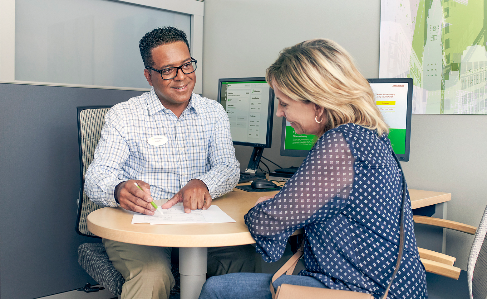 male tax pro helping female client to file taxes