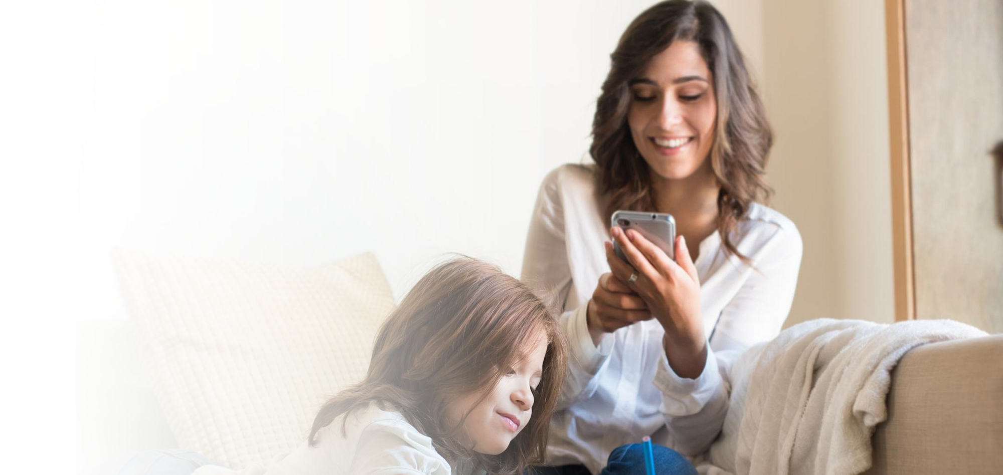 mother looking at Spruce app with daughter