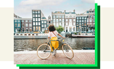woman living abroad out on a bike by a canal