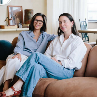 group shot of Seen Nutrition owners Adrienne Bitar and Jennifer Han sitting on a couch