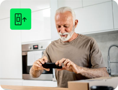 individual entering tax information on a smartphone using H&R Block Free Online tax filing service at home