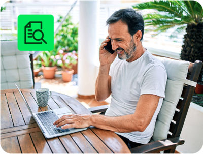 individual reviewing tax documents and filing taxes online with H&R Block free tax preparation on a laptop