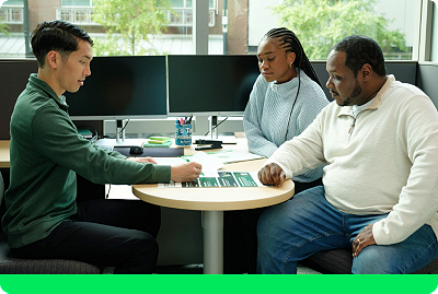 H&R Block customers meeting with tax pro in office