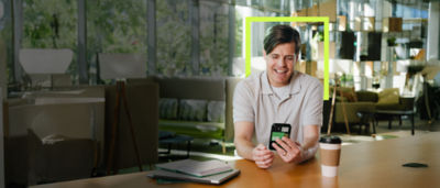 happy man using the Spruce app on his phone